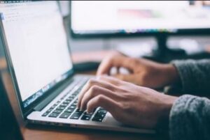 Person filling out form 990 online.